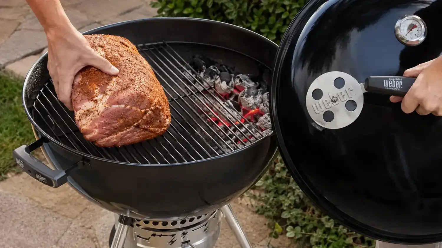 Thick bone-in chicken thighs finishing on the indirect side of a charcoal grill, lid closed, grill thermometer reading 375 degrees